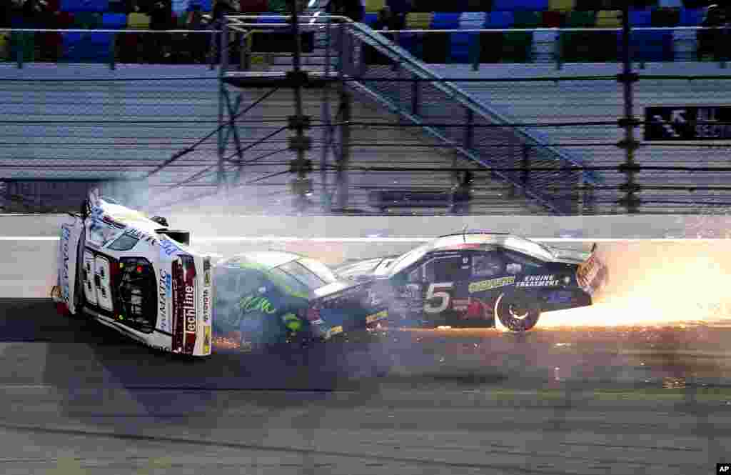 Justin Fontaine (33) flips as he crashes with Codie Rohrbaugh, center, and Bobby Gerhart (5) during an ARCA auto race at Daytona International Speedway in Daytona Beach, Florida, Feb. 18, 2017.