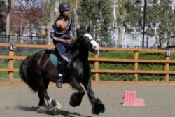 Mikhi Fearon, 17, rides Molly in a riding lesson at Ebony Horse Club, April 18, 2021.