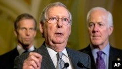 Senate Majority Leader Mitch McConnell of Ky., center, accompanied by Sen. John Thune, R-S.D., left, and Senate Majority Whip John Cornyn of Texas, speak during a news conference on Capitol Hill in Washington, Nov. 17, 2015. The Republican-led Senate is preparing to vote against the centerpieces of President Barack Obama’s environmental agenda.