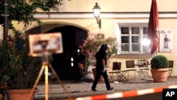 A special police officer examines the scene after an explosion occurred in Ansbach, Germany, Monday, July 25, 2016.