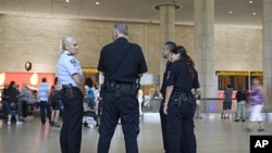 Israeli police officers stand guard at Ben Gurion international airport near Tel Aviv , July 7, 2011