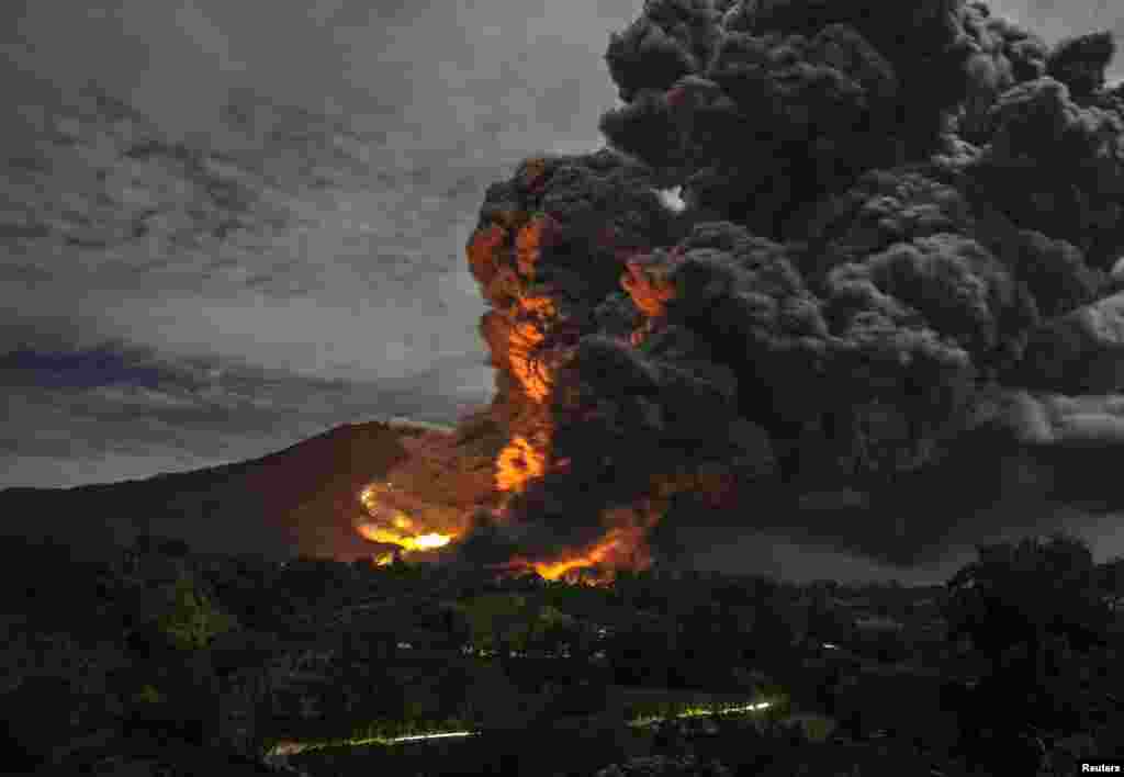 Mount Sinabung volcano erupts, as seen from Tiga Pancur village, Karo Regency in Indonesia's North Sumatra province. 