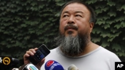 Chinese dissident artist Ai Weiwei listens as his lawyer announces over speakerphone the verdict of Ai's lawsuit against the tax authorities in Beijing, July 20, 2012.