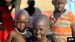 South Sudanese children are pictured at a refugee camp which was inundated by floods from the White Nile near in al-Qanaa in southern Sudan, on Sept. 14, 2021. 