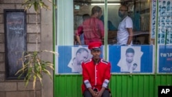 A security guard sits near a gate in Addis Ababa, Ethiopia, on October 10, 2016. Ethiopia's government on Monday blamed Egypt for supporting outlawed rebels and forcing the declaration of the country's first state of emergency in a quarter-century as widespread anti-government protests continue. Egypt has denied giving any support for the Ethiopian rebels.