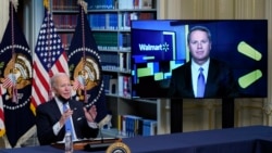 President Joe Biden speaks during a meeting with business leaders about the holiday shopping season, in the library of the Eisenhower Executive Office Building on the White House campus, Nov. 29, 2021, in Washington, as Doug McMillon, CEO of Walmart, listens.