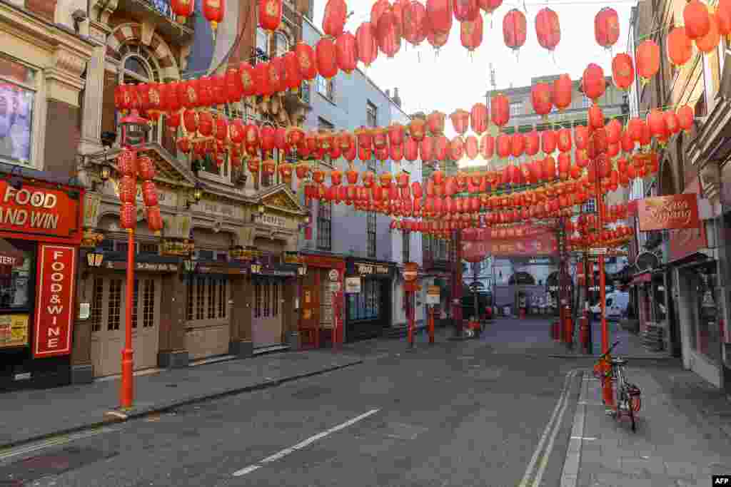 Pedestrians walk through the almost deserted streets of London&#39;s China Town district. As the deadly 2019-nCov strain of coronavirus has spread worldwide, it has carried with it xenophobia -- and Asian communities around the world are finding themselves subject to suspicion and fear.
