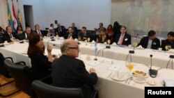 Argentina's President Cristina Fernandez (L, foreground) participates in a working breakfast with her counterparts of the Mercosur trade bloc and special guests summit in Montevideo, Uruguay, July 12, 2013. 