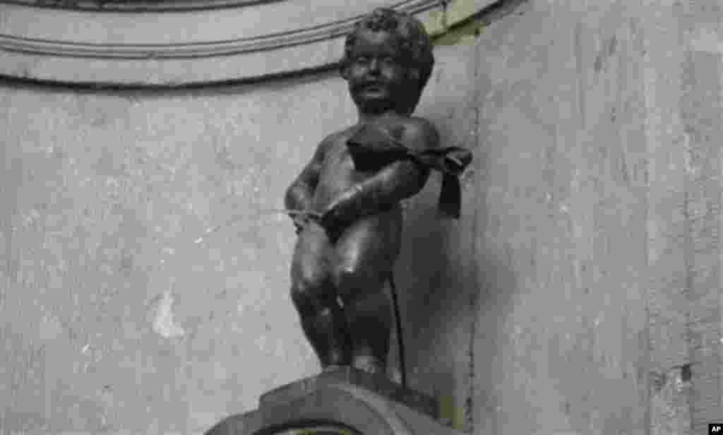 Brussels iconic statue 'Manneken Pis' is adorned with a black armband on Friday, March 16, 2012. A coach accident in Switzerland left 28 dead, including 22 children from Belgium traveling home after a skiing holiday. Belgium holds a national day of mourn