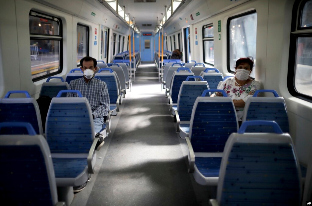 មនុស្ស​ពាក់​ម៉ាស​ដើម្បី​ការពារ​ការ​ឆ្លង​មេរោគ​កូរ៉ូណា កំពុង​ជិះ​រថ​ភ្លើង​ដែល​គ្មាន​មនុស្ស​ជិះ នៅ​ទីក្រុង​ប៊ុណូស៊ែ ប្រទេស​អាហ្សង់ទីន។