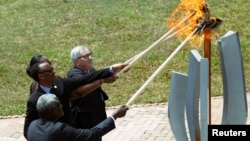 AU Commission Chairperson Moussa Faki Mahamat, Rwandan President Kagame, Jeannette Kagame and EU Commission President Juncker, light the Flame of Hope at the Genocide Memorial in Gisozi in Kigali, Apr. 7, 2019.