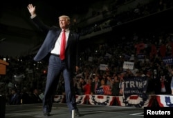 FILE - Republican U.S. presidential nominee Donald Trump arrives on stage at a campaign rally in Wilkes-Barre, Pennsylvania, Oct. 10, 2016.