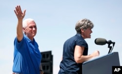 Vice President Mike Pence waves to supporters as U.S. Sen. Joni Ernst, R-Iowa, speaks during her annual fundraiser, June 3, 2017, in Boone, Iowa.