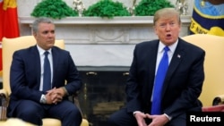U.S. President Donald Trump talks with reporters as he sits with Colombian President Ivan Duque at the start of a meeting in the Oval Office of the White House in Washington, Feb. 13, 2019.