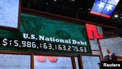 Republican National Committee Chairman Reince Priebus unveils a large U.S. national debt clock at the opening of the 2012 Republican National Convention in Tampa, Florida, August 27, 2012.