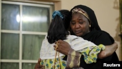 Mourners embrace each other as they pay their respects to the family of Bilikisu Yusuf in Kaduna, Nigeria, Sept. 26, 2015. Yusuf was one of the victims of a stampede during the hajj pilgrimage in Saudi Arabia's Mina. 