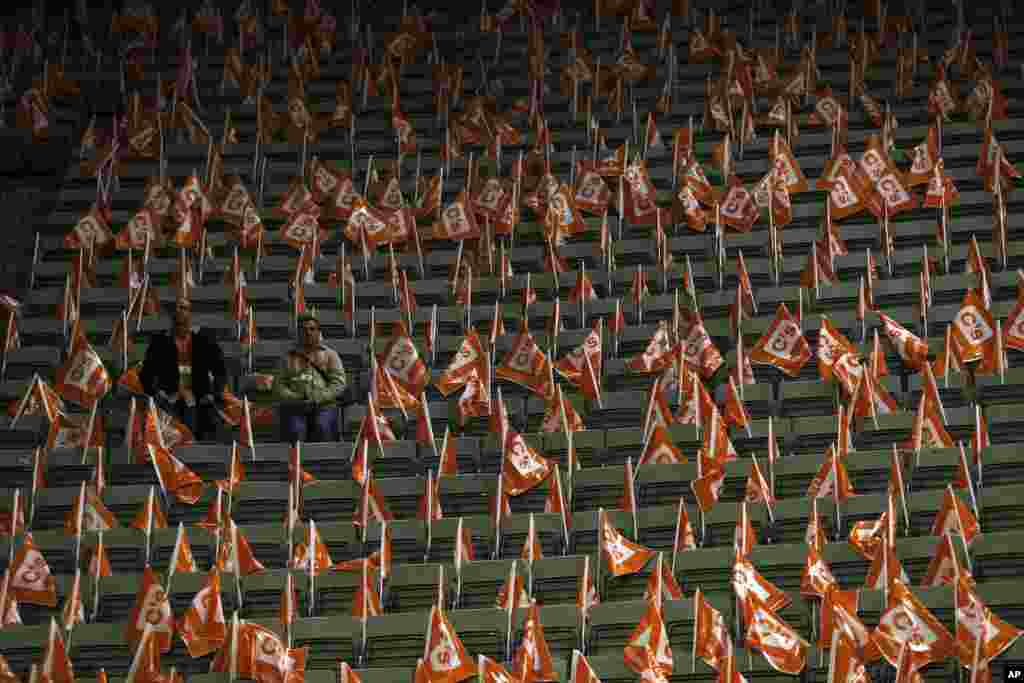 Volunteers surrounded by Spanish Ciudadanos party flags wait for the start of a campaign rally at the Palacio Vistalegre arena in Madrid.