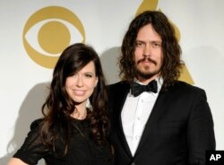 In this Nov. 30, 2011 file photo, Joy Williams, left, and John Paul White of the band The Civil Wars pose backstage at the Grammy Nominations Concert in Los Angeles.