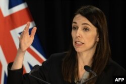 New Zealand's Prime Minister Jacinda Ardern speaks to the media regarding the latest case of COVID-19 coronavirus infections, breaking a 102-day run of no local transmissions, at the parliament in Auckland on August 12, 2020. - New Zealand's dream run of