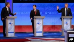 Candidates Jeb Bush, left, and Donald Trump, right, spar as Sen. Marco Rubio listens in the middle during a Republican presidential debate at St. Anselm College, Feb. 6, 2016, in Manchester, N.H.