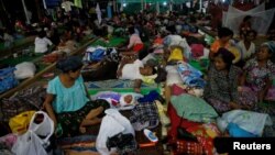 FILE - People displaced in the conflict between Kachin Independence Army (KIA) and Myanmar military for the control of an amber mine pass their time at a Christian church in Tanai township, Kachin state, Myanmar, June 16, 2017.