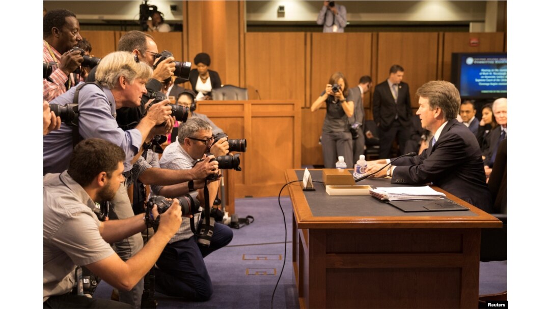 Supreme Court nominee Brett Kavanaugh faces photographers as he prepares to testify during the third day of his confirmation hearing before the Senate Judiciary Committee on Capitol Hill in Washington, Sept. 6, 2018.