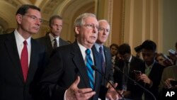 Senate Majority Leader Mitch McConnell of Kentucky, joined by, from left, Sen. John Barrasso, R-Wyo., Sen. John Thune, R-S.D., the Republican Conference chairman, and Senate Majority Whip John Cornyn of Texas, meets with reporters after a closed-door Republican strategy session on Capitol Hill in Washington, July 11, 2017.