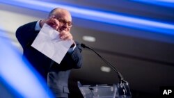 FILE - Rudy Giuliani, an attorney for President Donald Trump, pretends to tear a piece of paper as he speaks about the Iran nuclear agreement at the Iran Freedom Convention for Human Rights and Democracy at the Grand Hyatt in Washington, May 5, 2018.