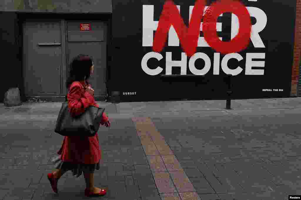 A woman walks past a new pro-choice mural by a graffiti artist collective called "Subset" ahead of a May 25 referendum on abortion law, in Dublin, Ireland.