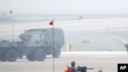 Soldiers in armored vehicles take part in an anti-airborne drill as part of the annual Han Kuang military exercise at the Chingchuankang Air Force Base in Taichung, central Taiwan, April 14, 2011.