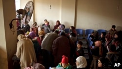 FILE - Syrians waiting for their appointments at the U.N. refugee agency's registration center in Zahleh, in Lebanon's Bekaa Valley. In Lebanon, Dec. 18, 2013