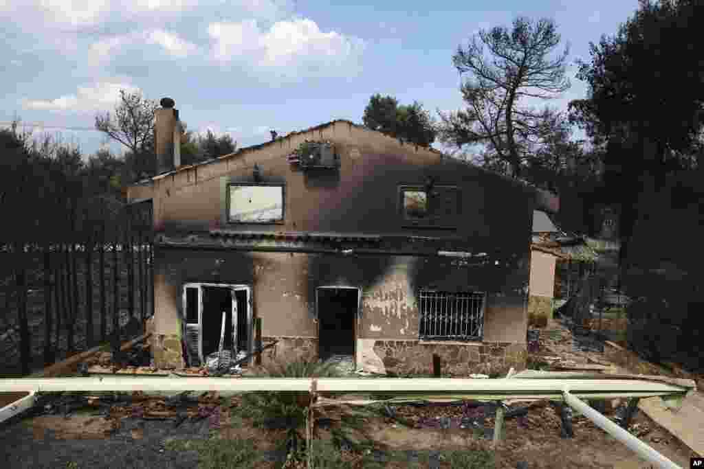A burned house is seen in Agios Andreas, east of Athens, Tuesday, July 24, 2018. 