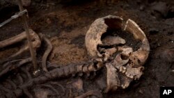 A skeleton lies in the ground on the archeological excavation site at the 16th and 17th century Bedlam burial ground, uncovered by work on the new Crossrail train line next to Liverpool Street station in London, March 6, 2015.