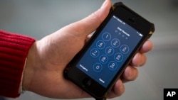 FILE - A locked iPhone is seen in Washington, Feb. 17, 2016. 