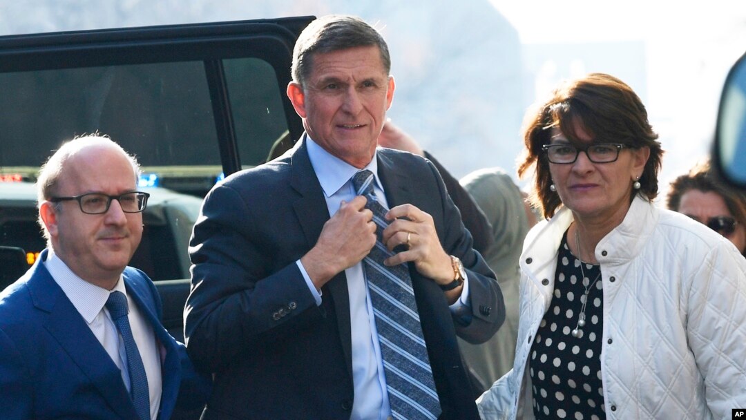 FILE - Former Trump national security adviser Michael Flynn, center, arrives at federal court in Washington, Dec. 1, 2017.