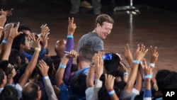 Facebook’s CEO Mark Zuckerberg interacts with technology students in a town hall-style meeting in New Delhi, India, Oct. 28, 2015.