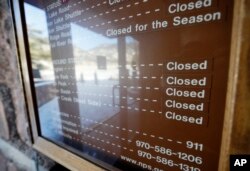 Sign inside the main visitors center notes that campgrounds are closed at Rocky Mountain National Park, Dec. 22, 2018, in Estes Park, Colorado