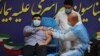 Parsa Namaki, putra Menteri Kesehatan Saeed Namaki, menerima vaksin Sputnik V dari Rusia di Rumah Sakit Imam Khomeini di Teheran, Iran, Selasa, 9 Februari 2021. (Foto AP / Vahid Salemi)
