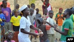 Children are seen playing with their teachers in the yard of a Catholic school in Blangoua, northern Cameroon, in this March 1, 2013, file photo.