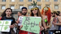 FILE - Activists gather during a rally in support of marijuana legalization in central Tbilisi, Georgia, June 2, 2015. The Georgian Constitutional Court legalized marijuana consumption, July 30, 2018, while retaining laws against growing, storing and selling the drug.