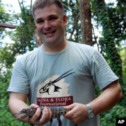 Adam Scott, head of the crocodile project at Fauna and Flora International, holding a hatchling Siamese crocodile at Phnom Tamao Wildlife Rescue Centre