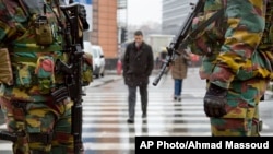 Belgian soldiers patrol the EU headquarters in Brussels on Monday, Jan. 19, 2015. Security has been stepped up after thirteen people were detained in Belgium in an anti-terror sweep following a firefight in Verviers. Two suspected terrorists were killed. (AP Photo/Virginia Mayo)