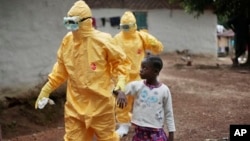 FILE - Nowa Paye, 9, is taken to an ambulance after showing signs of the Ebola infection in the village of Freeman Reserve, about 30 miles north of Monrovia, Liberia, Sept. 30, 2014.