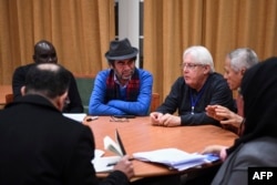 U.N. special envoy to Yemen Martin Griffiths, third right, takes part in a work group with a member of a Yemeni government's delegation, Abdulaziz Jabari, not pictured, and with a rebel delegation member Salim al-Moughaless, not pictured, as part of peace consultations taking place at Johannesberg Castle in Rimbo, north of Stockholm, Sweden, Dec. 12, 2018.