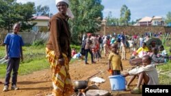 A refugee from the Democratic Republic of Congo is seen with her children near the United Nations High Commissioner for Refugees (UNHCR) offices in Kiziba refugee camp in Karongi District, Rwanda, Feb. 21, 2018.