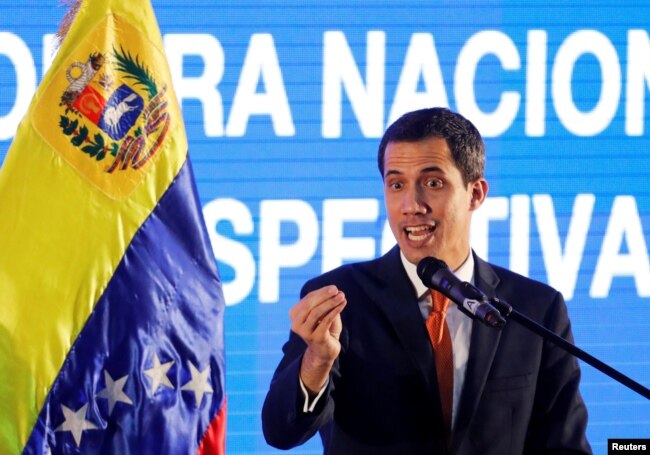 Venezuelan opposition leader Juan Guaido, who many nations have recognized as the country's rightful interim ruler, speaks during a meeting with representatives of the oil sector in Caracas, Venezuela, Feb. 5, 2019.