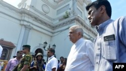 FILE - Sri Lankan Prime Minister Ranil Wickremasinghe (2nd R) arrives to visit the site of a bomb attack at St. Anthony's Shrine in Kochchikade in Colombo, April 21, 2019. 