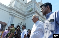 Sri Lankan Prime Minister Ranil Wickremasinghe (2nd R) arrives to visit the site of a bomb attack at St. Anthony's Shrine in Kochchikade in Colombo, April 21, 2019.