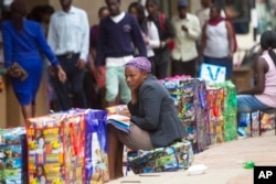 FILE - A bag vendor waits for clients on a street in Harare, Zimbabwe, Dec. 20, 2016. Many people in this once-prosperous southern African country are struggling to make ends meet as the economy implodes.