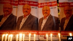 Candles in memory of Saudi journalist Jamal Khashoggi burn outside the Saudi consulate, in Istanbul, Turkey, Oct. 25, 2018.